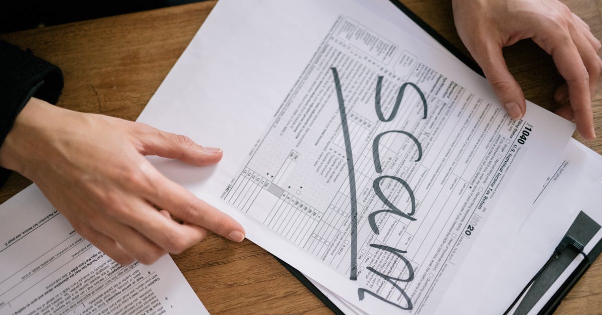 Mãos segurando formulário de imposto com a palavra SCAM escrita em letras grandes sobre o papel. — Foto: Leeloo The First