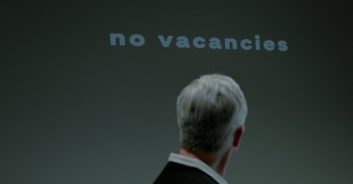 Seguro desemprego 79021 1772550094 Homem de costas olhando para uma parede com a frase 'no vacancies', indicando falta de vagas de emprego. — foto: ron lach