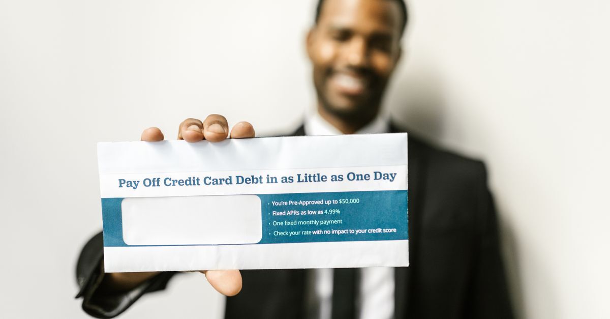 Negativacao indevida inline 1 87767 1785001153 Homem segurando envelope com mensagem sobre dívida de cartão de crédito.