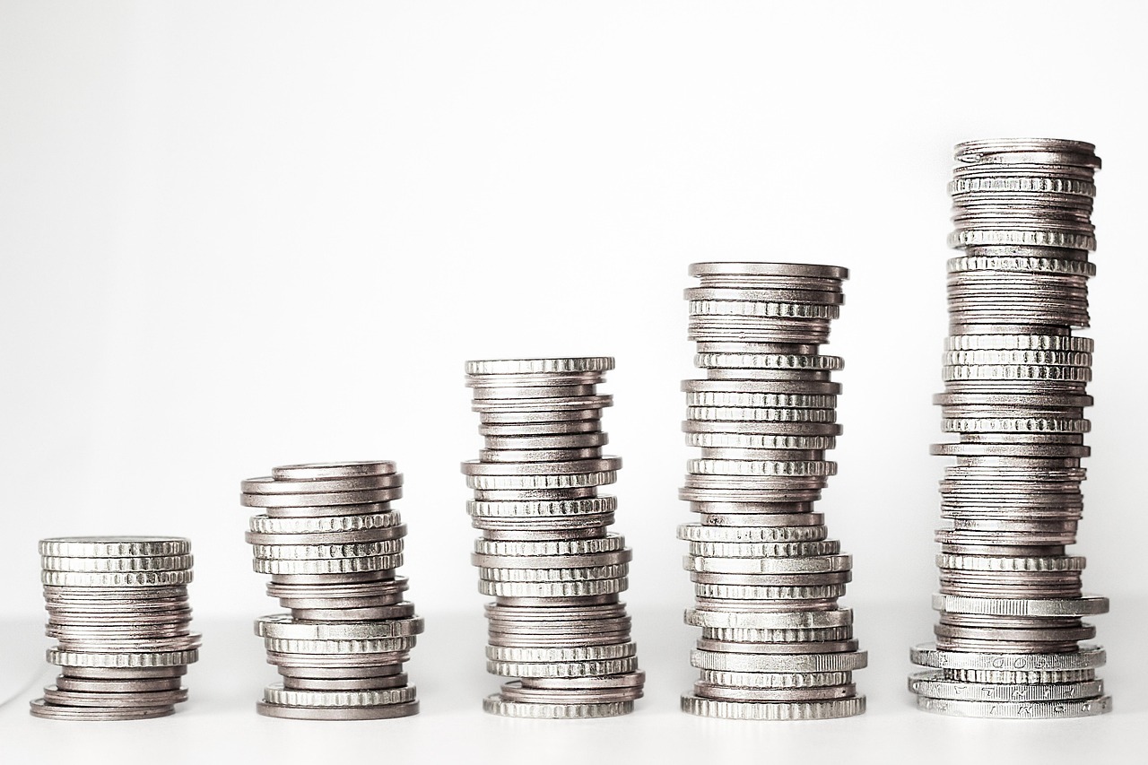 Pilhas de moedas crescentes em ordem, simbolizando crescimento financeiro.
